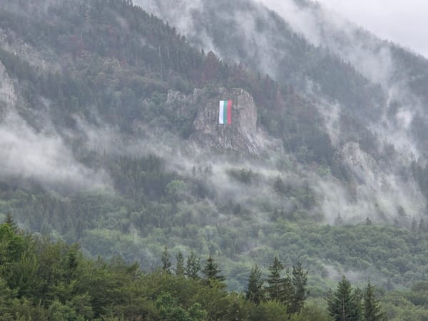 Bulgarian flag displayed on misty mountain outcrop near Smolyan