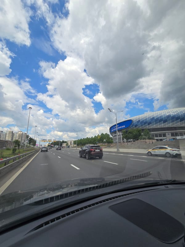 Morning traffic flows on Moscow highway under cloudy skies