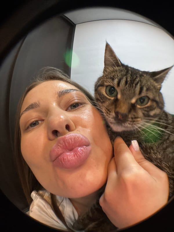 Woman takes selfies with tabby cat in Chernushka, Russia
