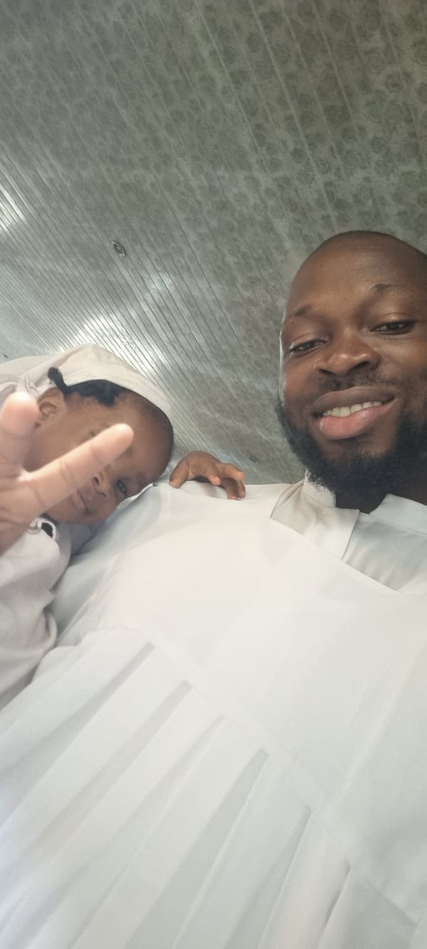 Three youth in white attire gather outside Lagos