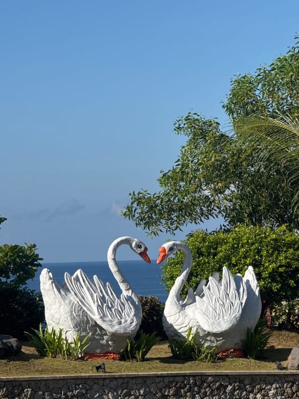 Six Balinese dancer statues observed overlooking ocean in Ungasan