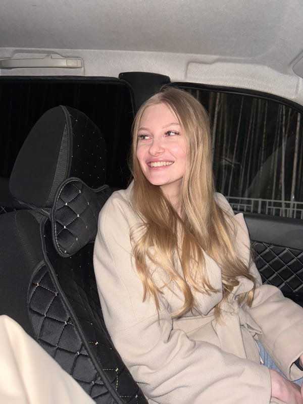 Woman photographed smiling in car during evening in Perm
