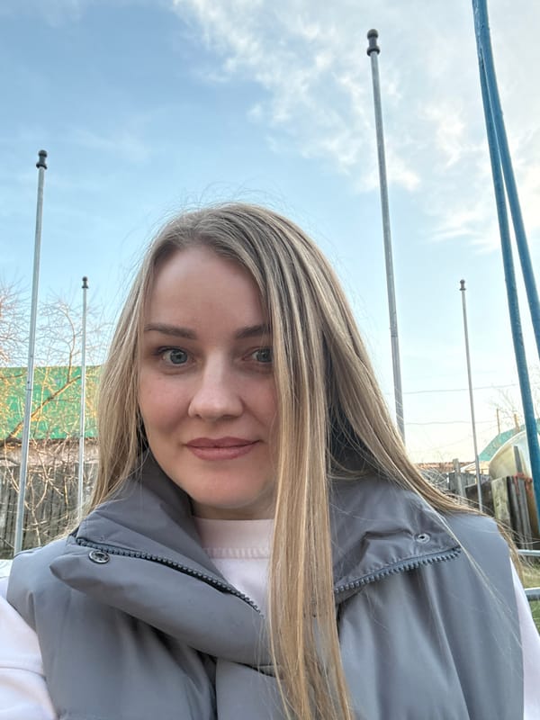 Woman photographs outdoor moments in Chaikovsky garden setting