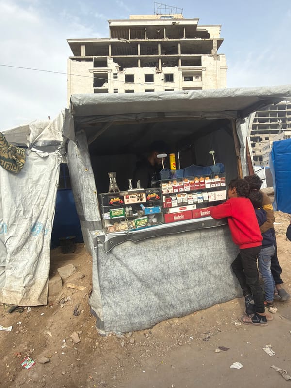 Vendor stall operates amid damaged buildings in Gaza