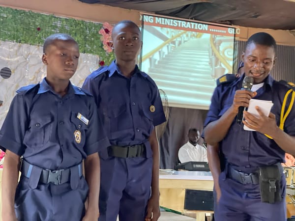 Uniformed youth ceremony and outdoor cooking activities in Akwanga