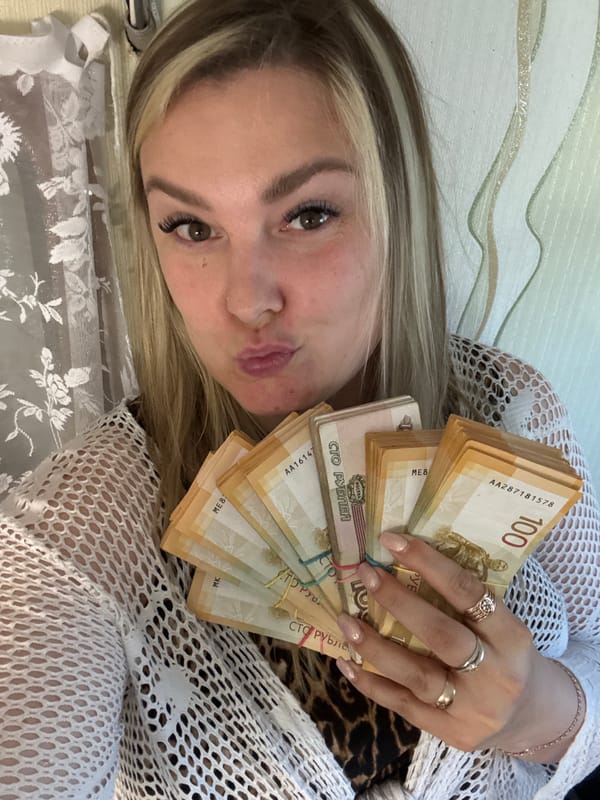 Woman counts stacks of Russian rubles at desk