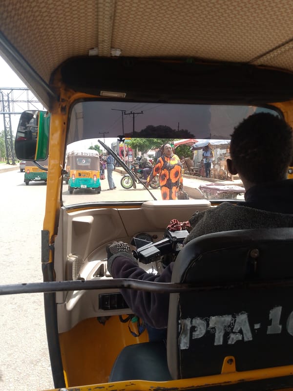 Tuk-tuk driver transports generator through Bukuru streets