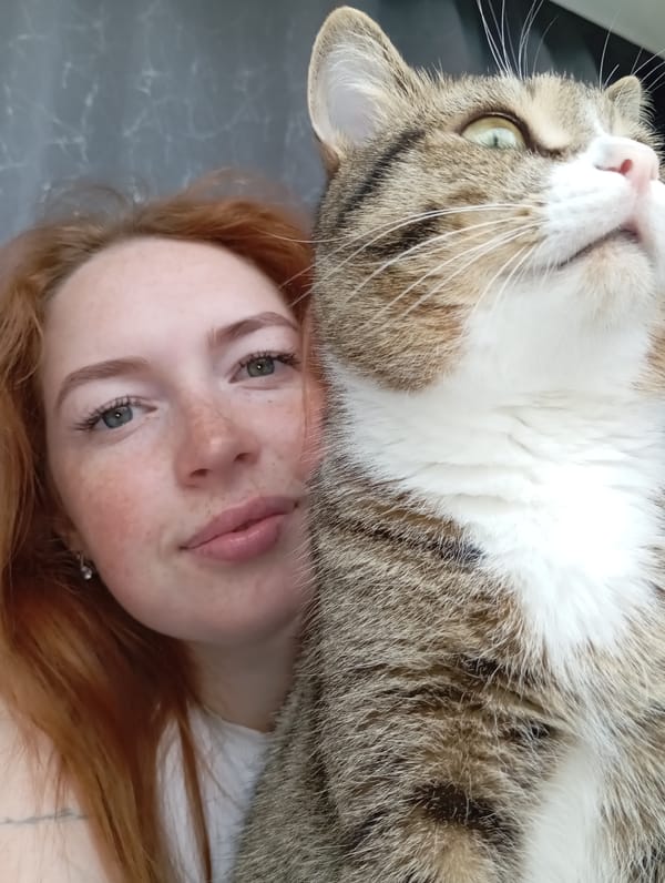 Woman and tabby cat share quiet morning moments in Yurgamysh