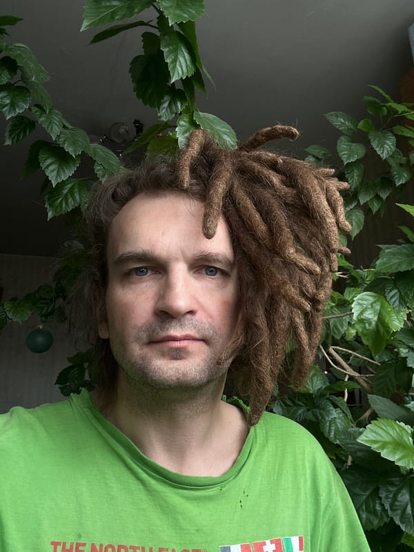 Man with dreadlocks spotted among plants in Biysk, Russia