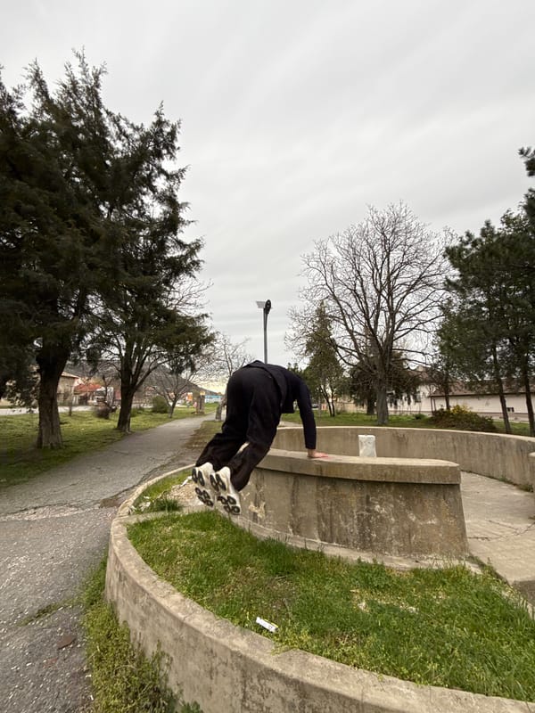 Man performs parkour tricks at concrete structure in Shumen park