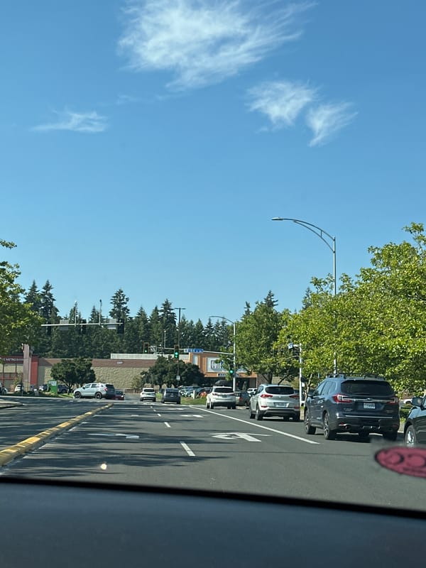 Coffee in hand, moving through a sunny Lynnwood afternoon