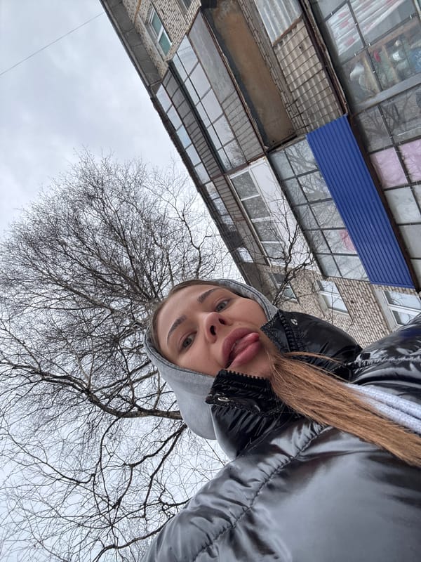 Woman poses playfully for camera in Chernushka, Russia