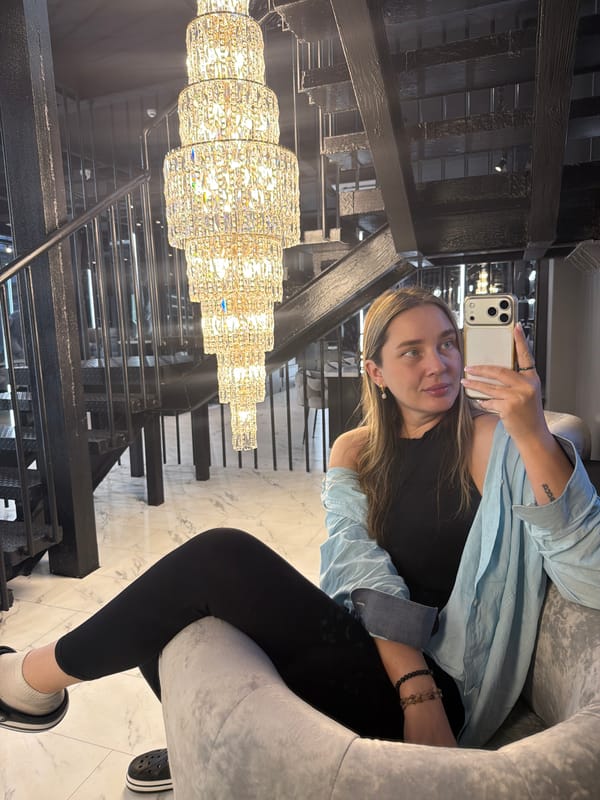 Woman takes selfies near staircase in Moscow interior