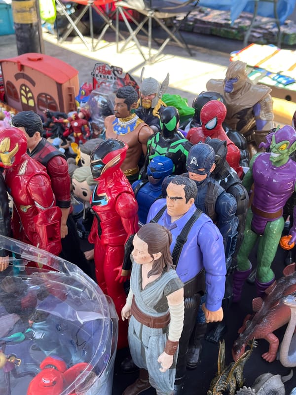 Action figures including superheroes displayed for sale outdoors