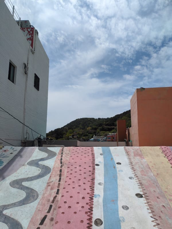 Tourists document vibrant street art in Busan's cultural village