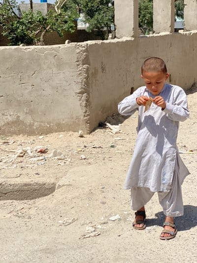 Boy and man observed in traditional dress in Kandahar