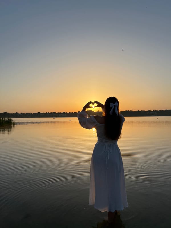 Heart framed around the setting sun in shallow water, Ternopil