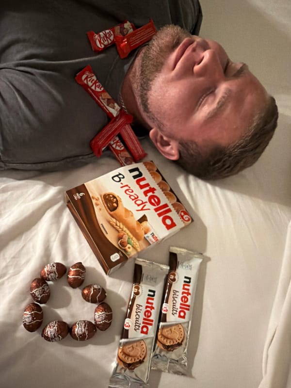 Man sleeps with Kit Kat necklace, Nutella snacks nearby