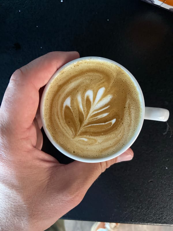 Man documents barista latte art creation at Montenegro cafe
