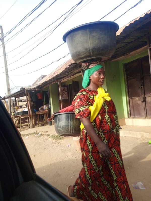 Street life captured: woman walking, motorcycle vendor transaction observed