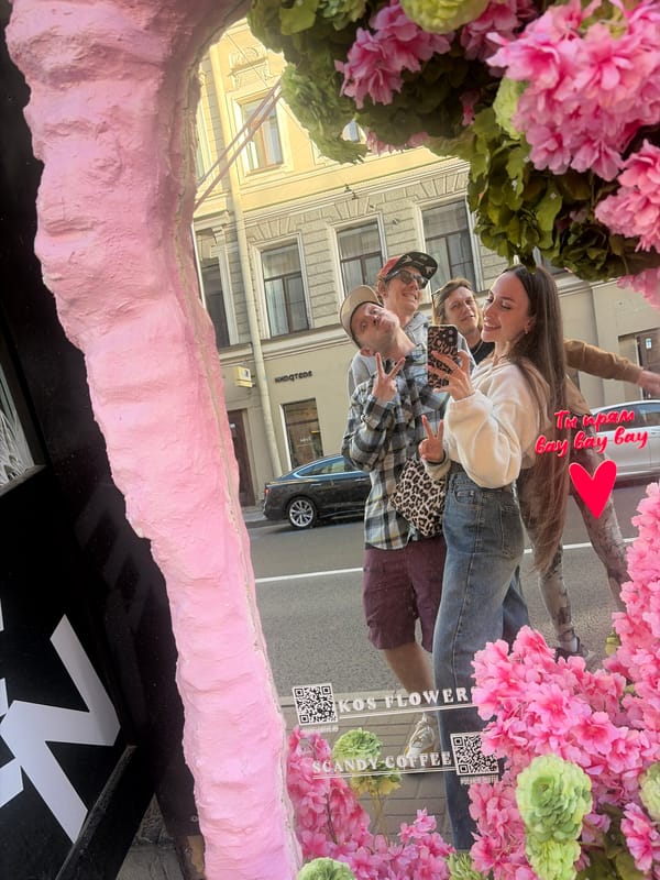 Tourist takes selfies around Saint Petersburg canals and shops