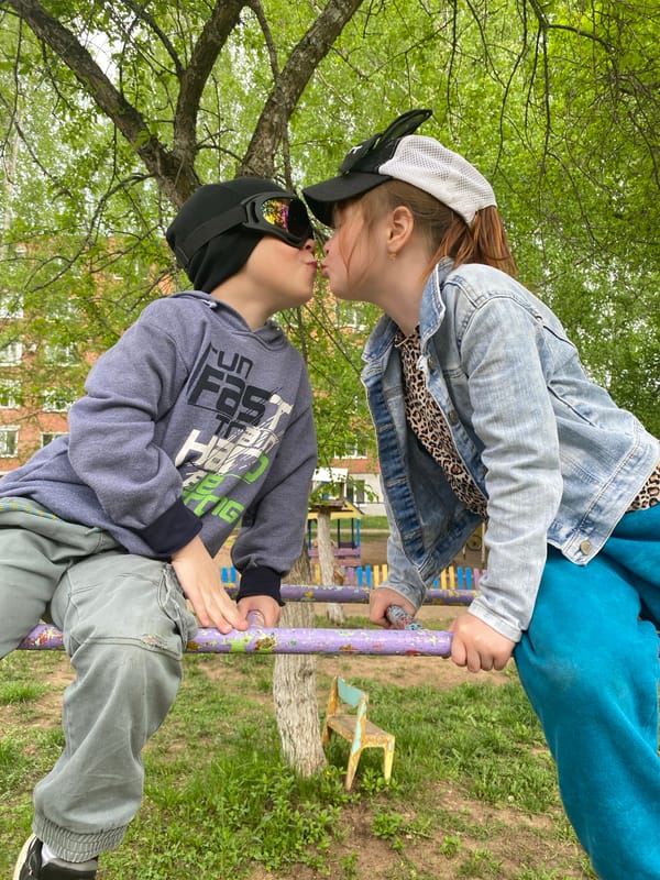 Children play at playground, woman photographed in Noviy, Russia