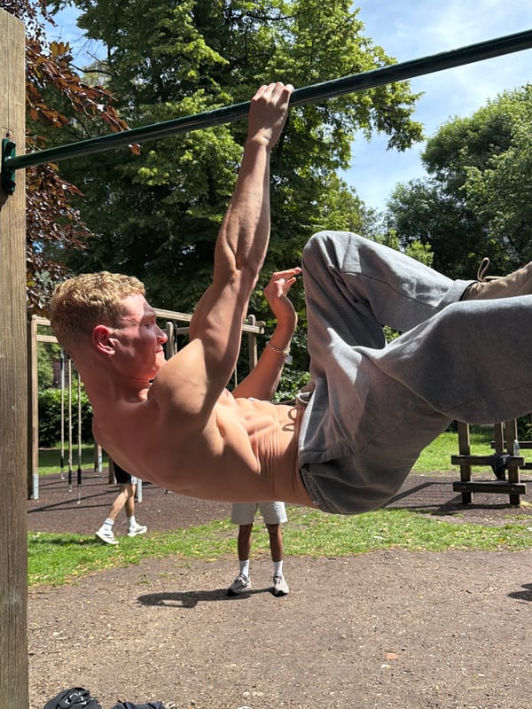 Man exercises outdoors in London park during morning workout