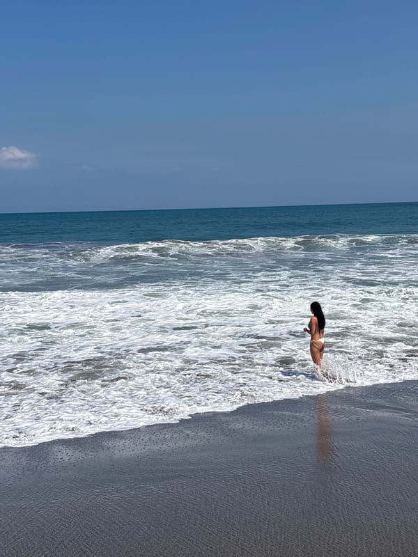 Sunny afternoon on North Kuta's dark sand beach