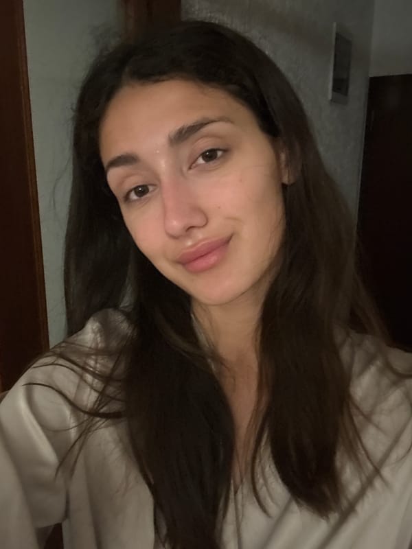 Woman documents evening skincare routine in Sutomore bathroom