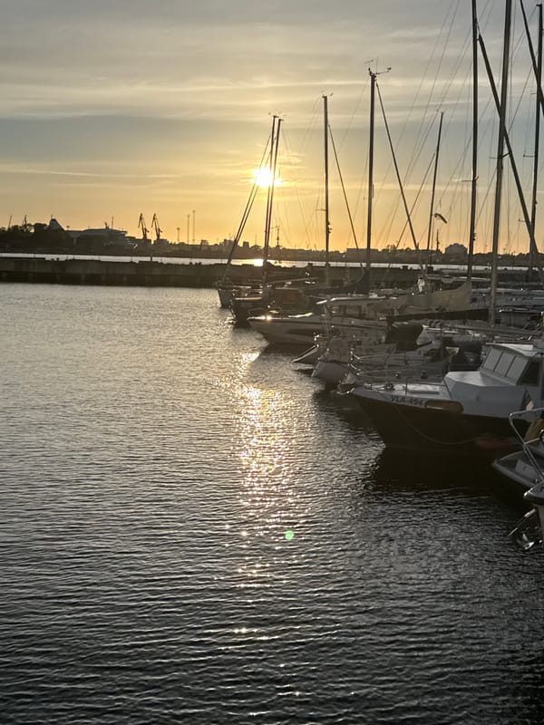 Sunset documented at Tallinn Harbor with boats and waterfront activity