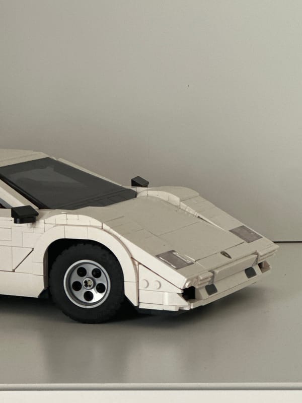 White LEGO-style vintage car model spotted upright in Milan