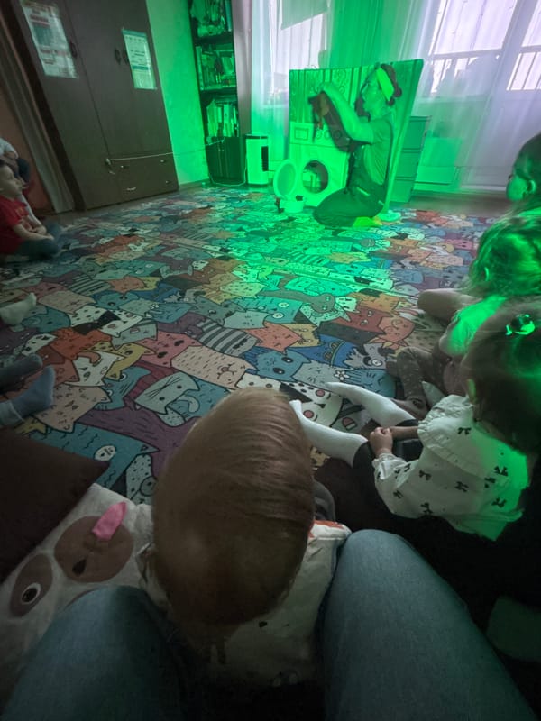 Children play on cat-themed rug in Russian home