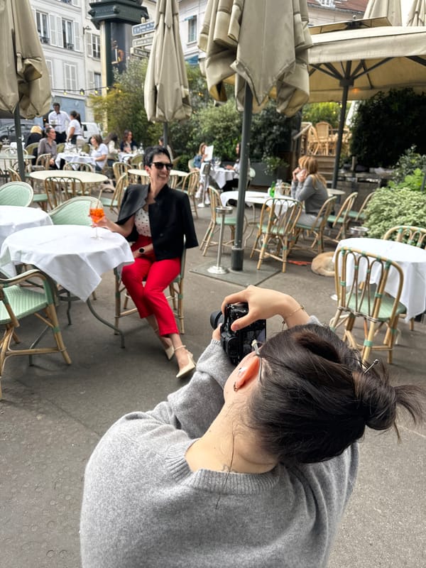 Woman poses for photos at Paris cafe