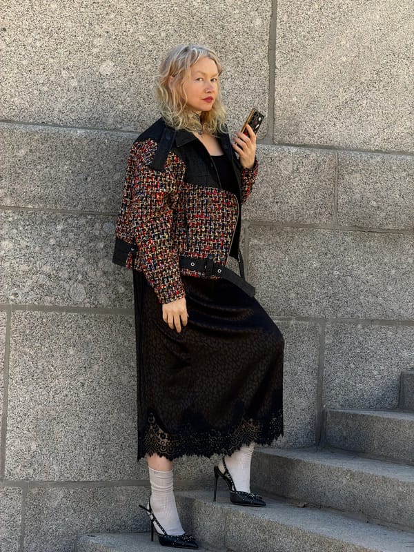 Woman with phone spotted on stone steps in Saint Petersburg