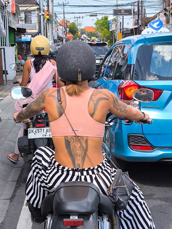 Women motorcyclists pause in Canggu traffic
