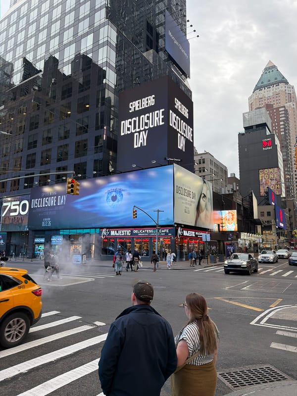Times Square billboards advertise Spielberg film, street activity observed