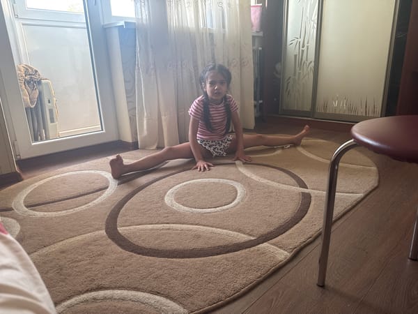 Child practices gymnastics at home during afternoon hours