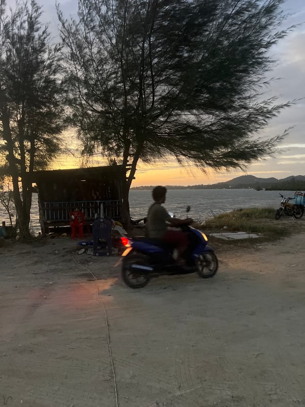 Dusk along Ko Pha-ngan's coast, boats, bikes, and shoreline