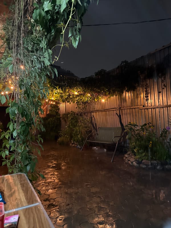 Rainy night on a lit patio in Almaty