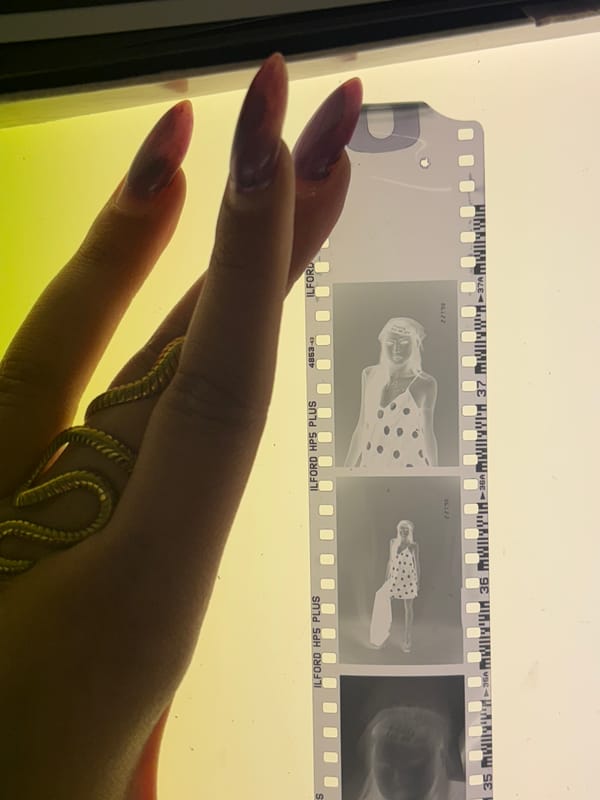 Photographer reviews film negatives in Milan studio session