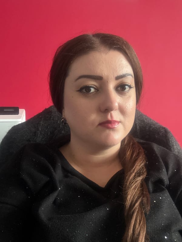 Woman takes selfie against red wall in Varna