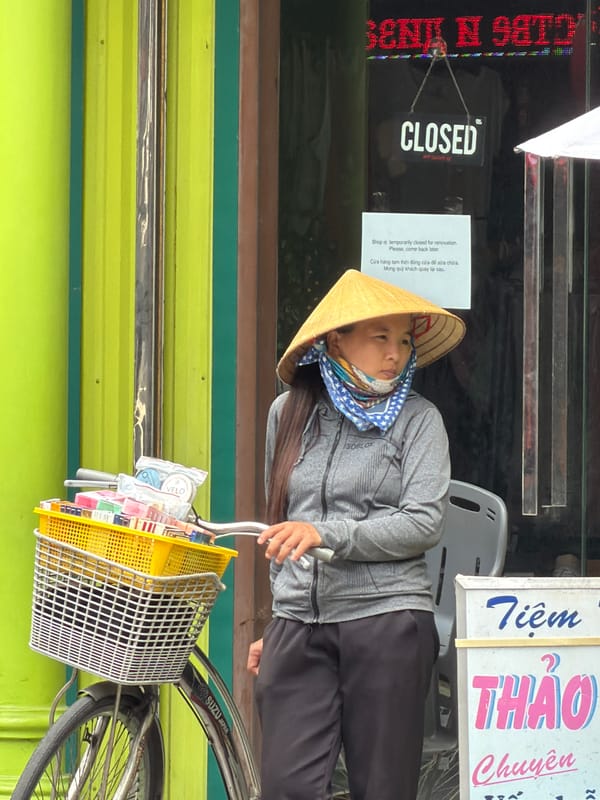 Nha Trang street scene: vendors, riders, and tourists mid-morning