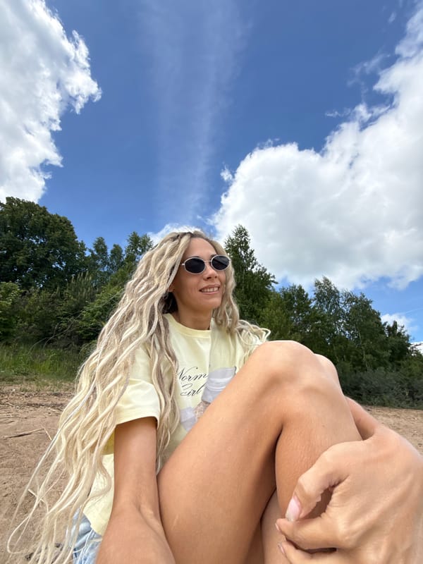 Woman with blonde braids photographed with child on sunny morning
