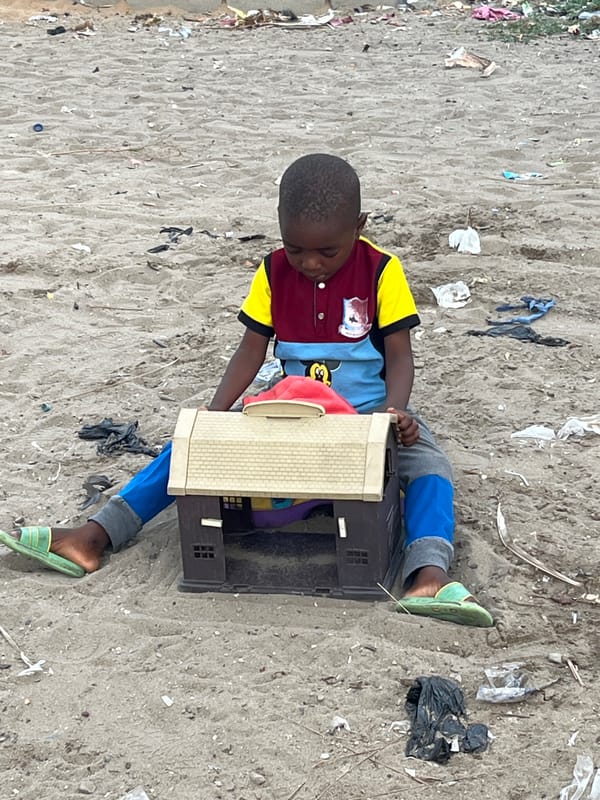 Children play on sandy surface in Badagry, Nigeria