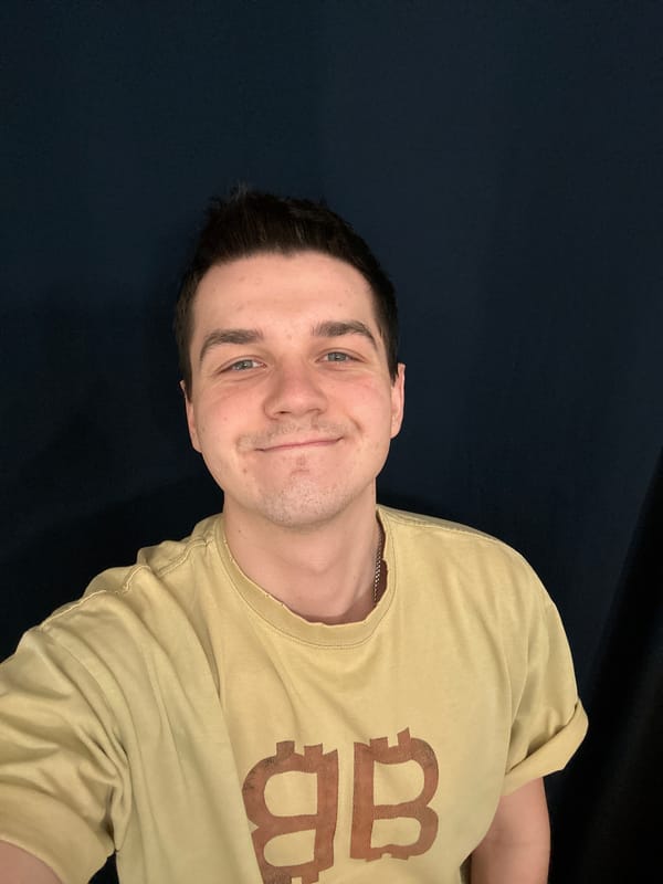 Young man poses for photo in yellow BB shirt