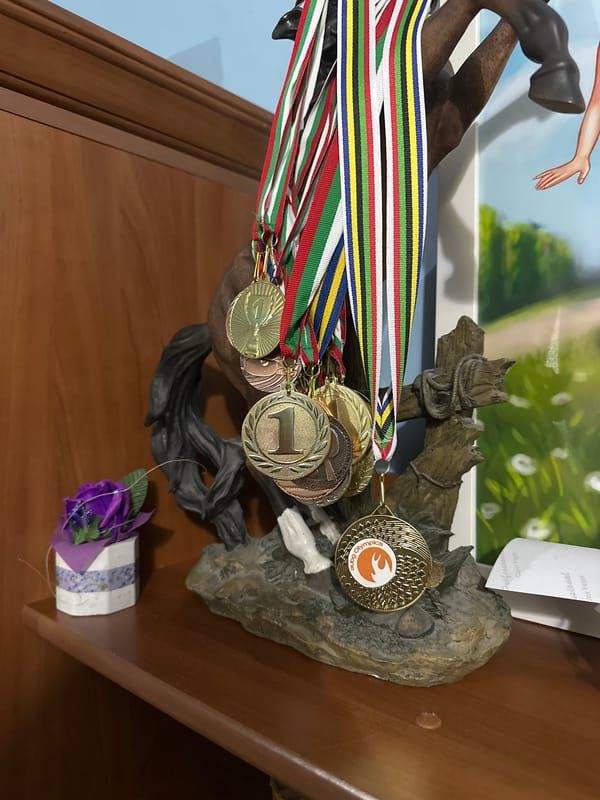 Home office workspace with medals and travel souvenirs displayed
