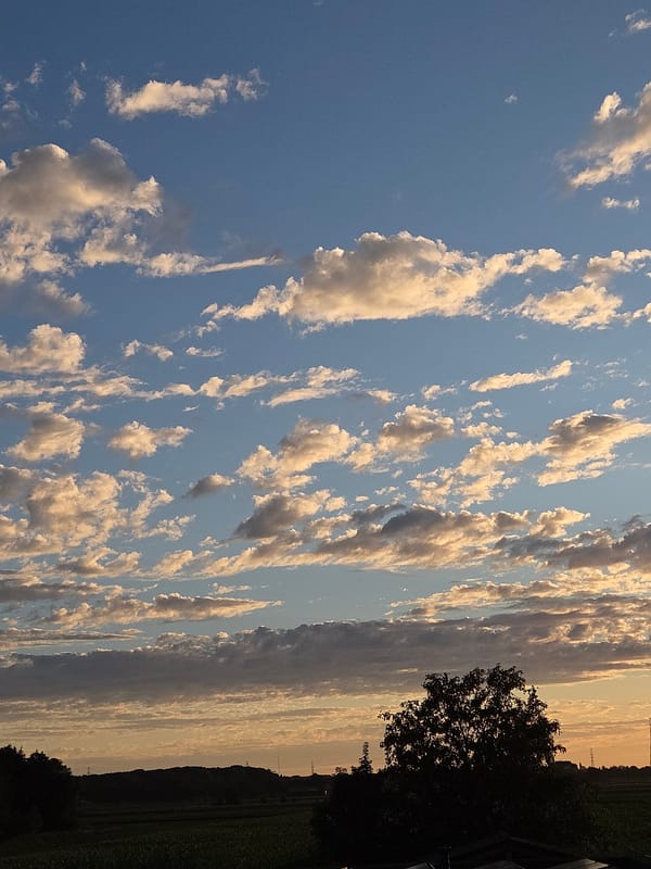Golden sunset over Eeklo's cloudy Belgian sky