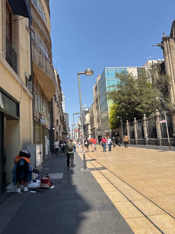 Pedestrians stroll through Mexico City walkways amid varied architecture
