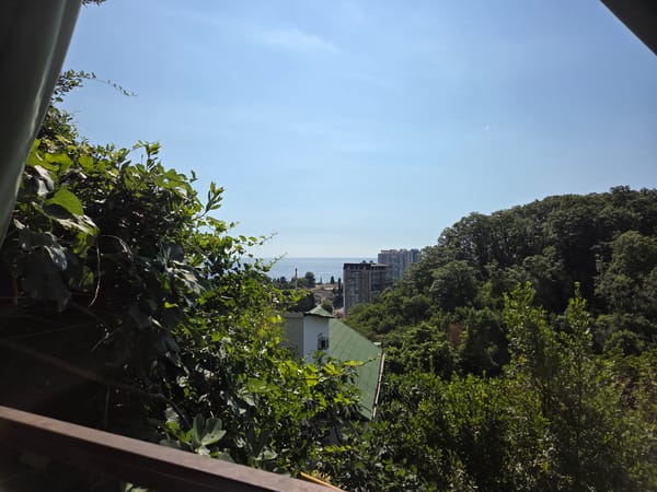 Balcony hangout with drinks, cigarettes, and sea views