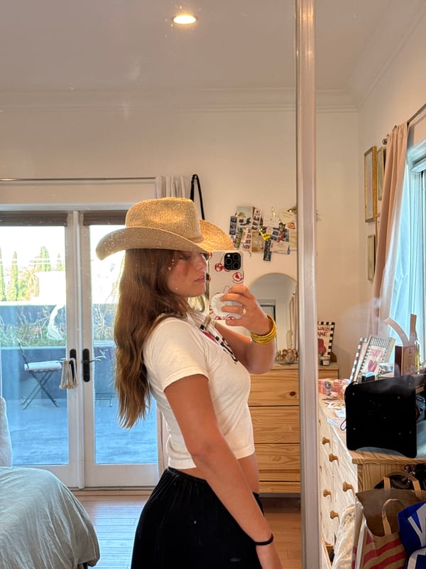 Woman takes mirror selfie in cowboy hat, Los Angeles